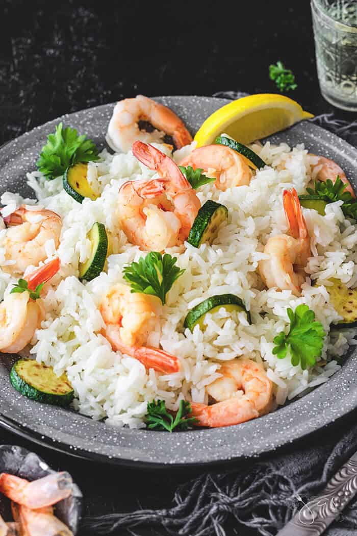 A front shot of Italian dish with rice, shrimp, and zucchini.