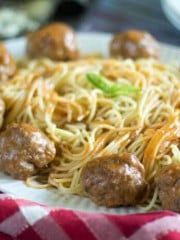 A close up of pasta and meatballs in a platter