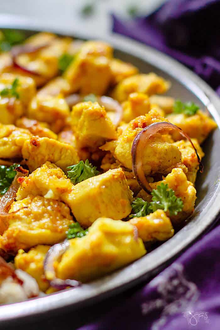 Angle close up shot of cooked chicken pieces with turmeric