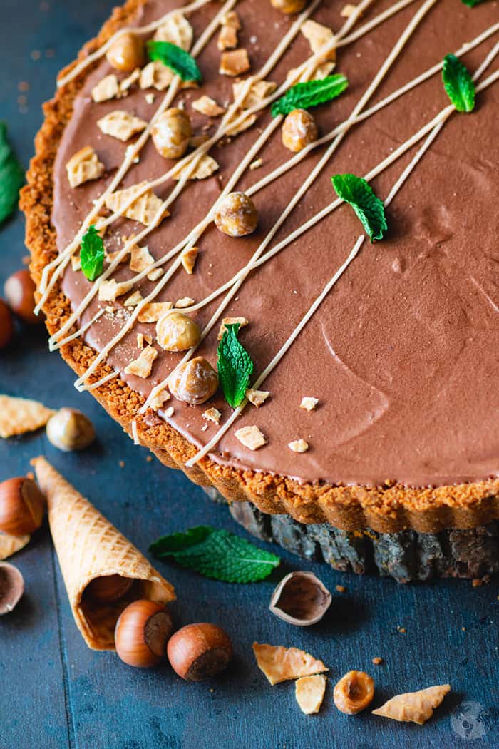 An angle shot of German-style tart with crispy sugar cone crust and chocolate mousse with Nutella.