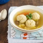 A bowl of food on a plate on a table
