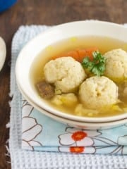 A bowl of food on a plate on a table