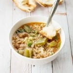 A bowl of pepper soup with a spoon