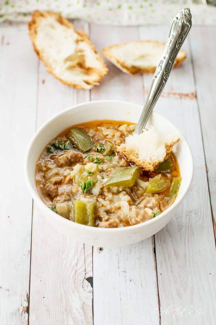 A bowl of pepper soup with a spoon