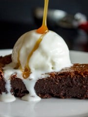 Nutella Baileys Brownie Cake with ice cream and a drizzle