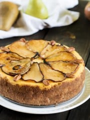 A plate of Cheesecake with sliced pears