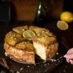 A person serving a piece of baklava cheesecake.