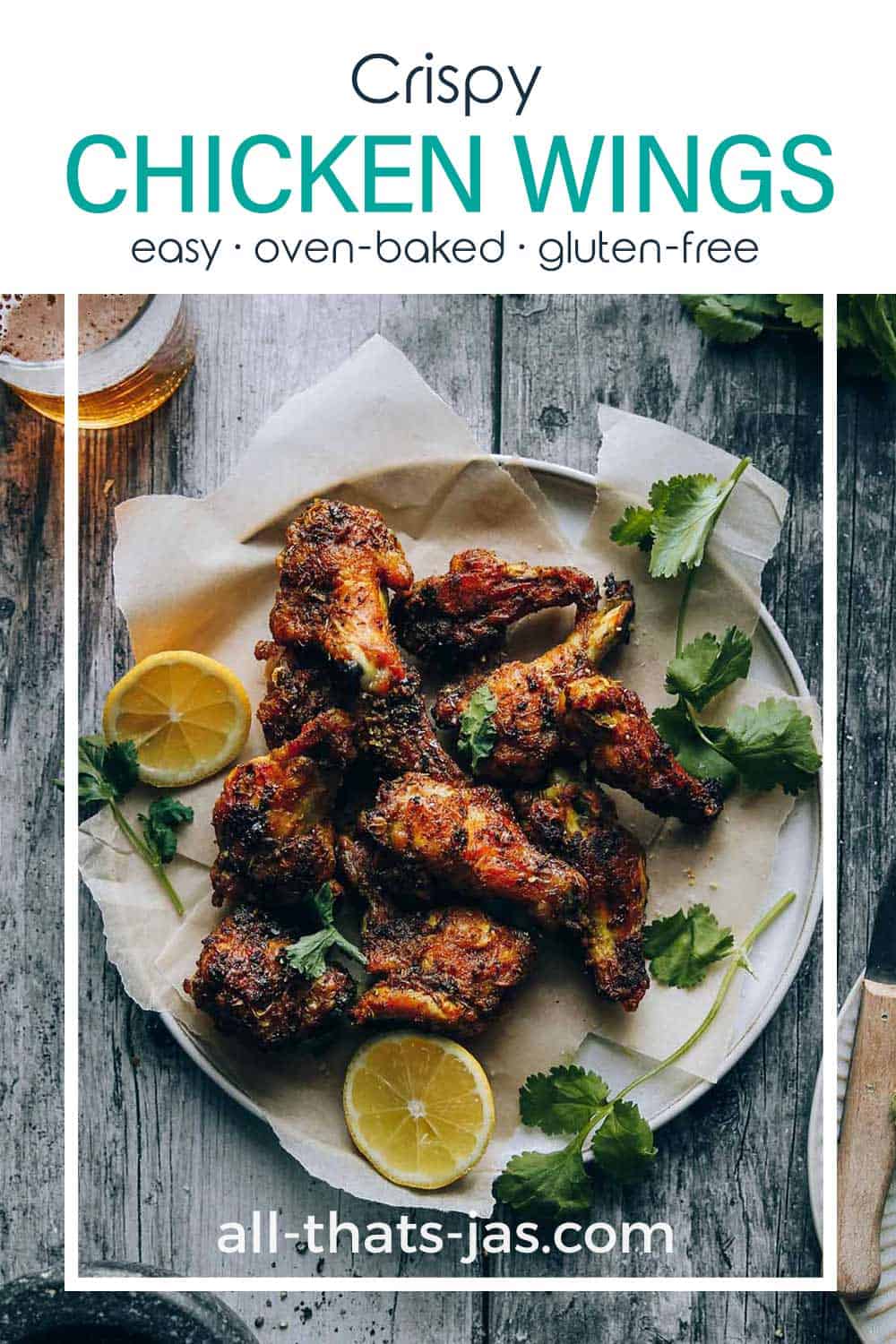 Wings on a plate with lemon slices and text overlay.