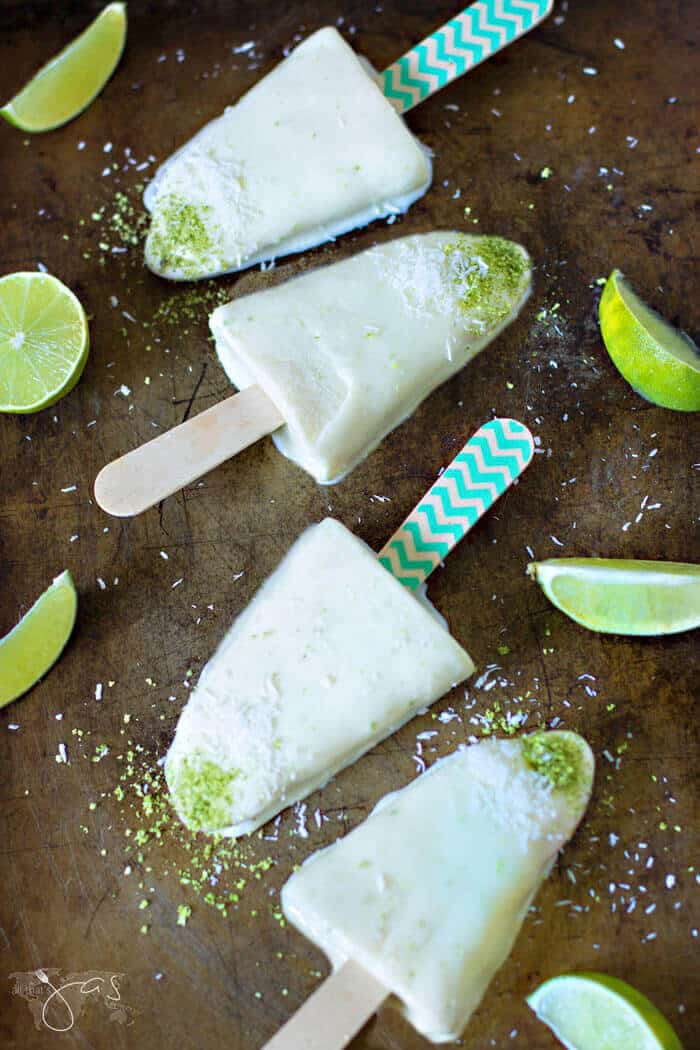 An overhead shot of ice cream bars in a row on a dark background