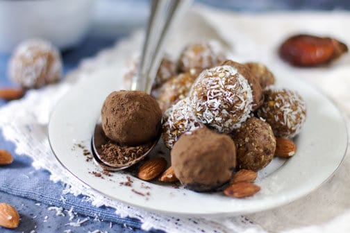 A plate with chocolate balls and spoon