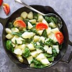 A skillet with vegetables on a counter