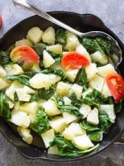 A skillet with vegetables on a counter