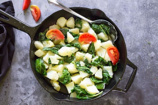 A skillet with vegetables on a counter