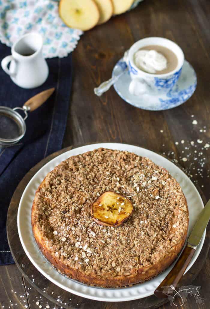 An overhead shot of the whole Bavarian cheesecake on a wooden background served with coffee.