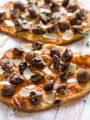 Two flatbread pizzas with mushrooms and cheese