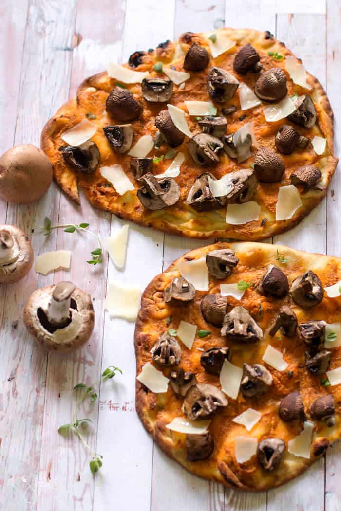 An overhead shot of naan pizza with mushrooms