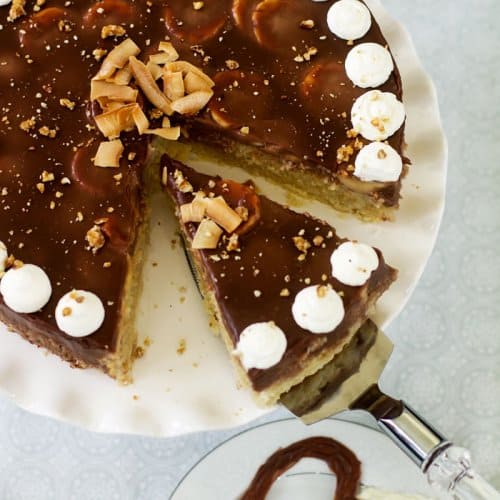 A chocolate cake with one slice being removed