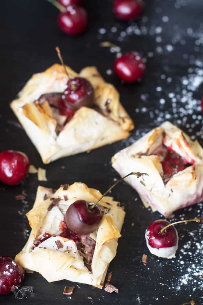 Fillo dessert with cherries on a table and powdered sugar