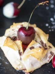 Fillo pastry sheets folded and topped with a cherry