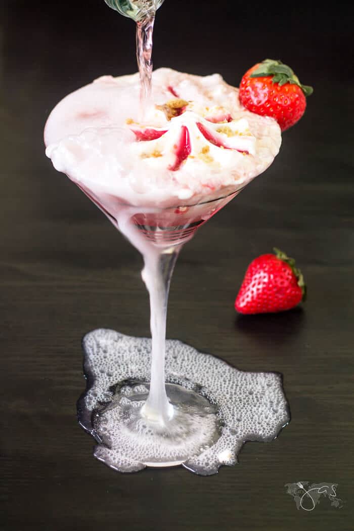 pouring sparkling wine over strawberry ice cream