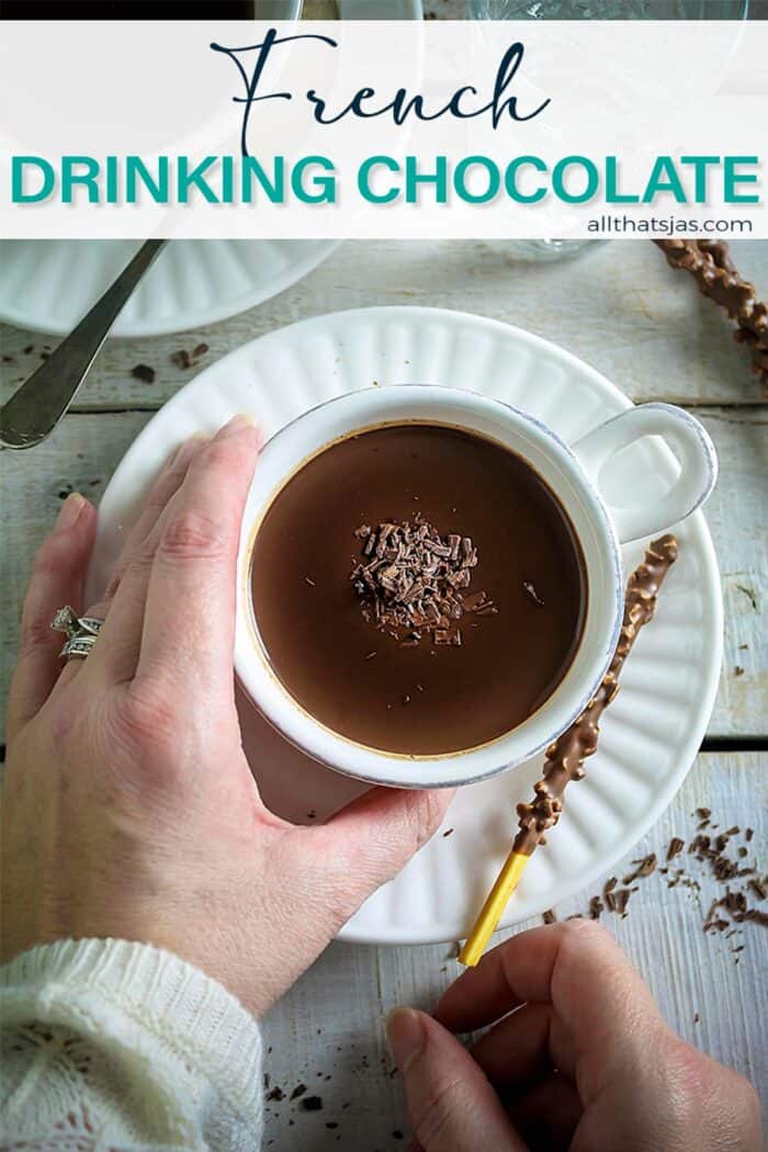 A hand holding the hot chocolate cup with text overlay