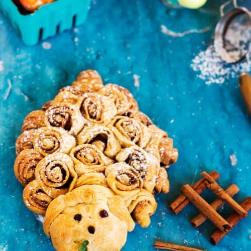 Cinnamon rolls in a shape of a lamb on a blue background.