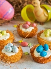 A bunch of pastry nests with candy eggs on top