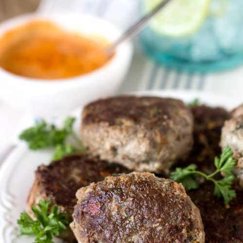 A bunch of rissoles on a plate.