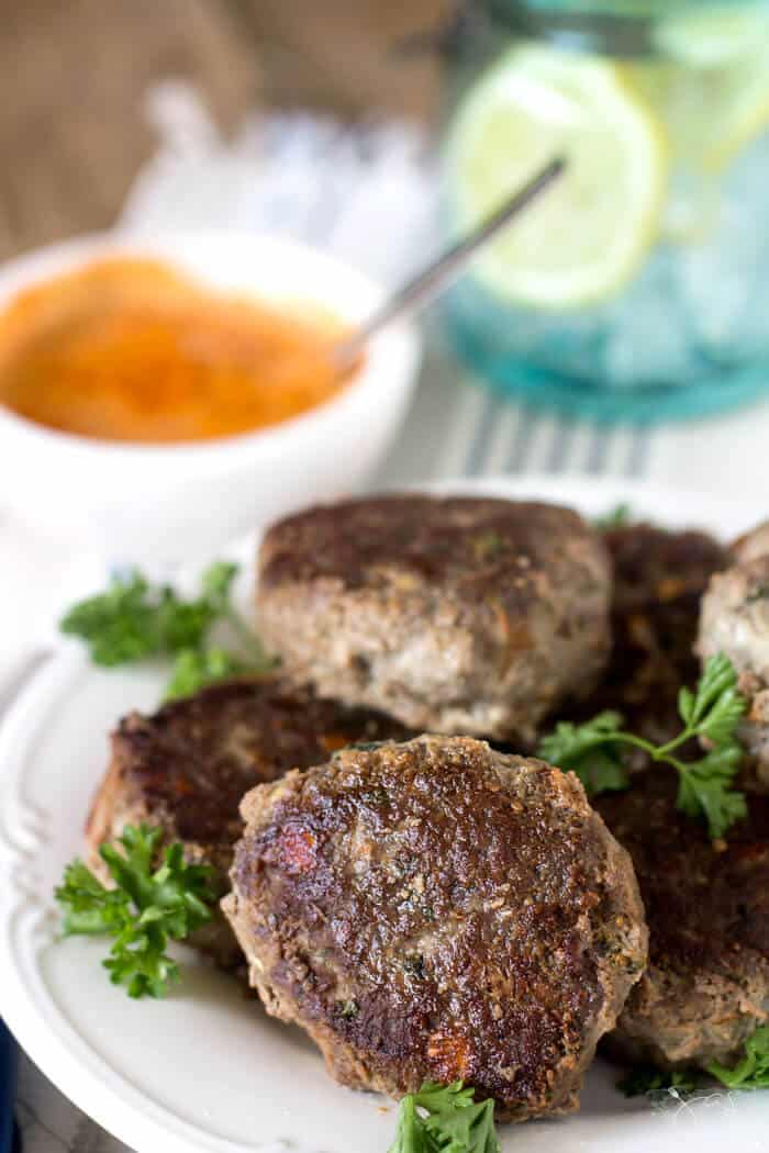 A bunch of rissoles on a plate.