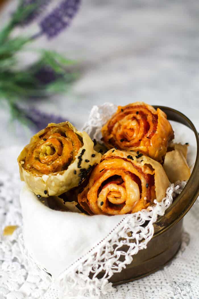 A close up of filled pastry pinwheels in a basket