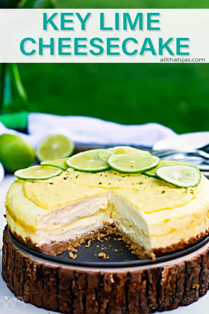 Cheesecake with key lime curd filling and topping on a wooden plank set outside in the grass