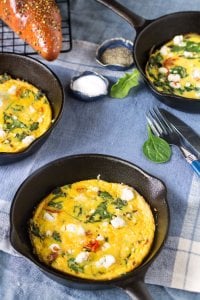 Frittata with goat cheese served in small skillets.