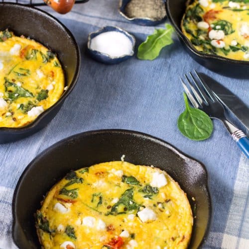 Frittata with goat cheese served in small skillets.