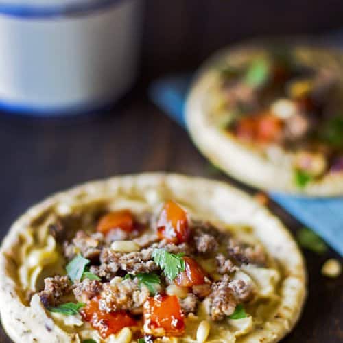 A close up of a plate of food, with Hummus and Pita