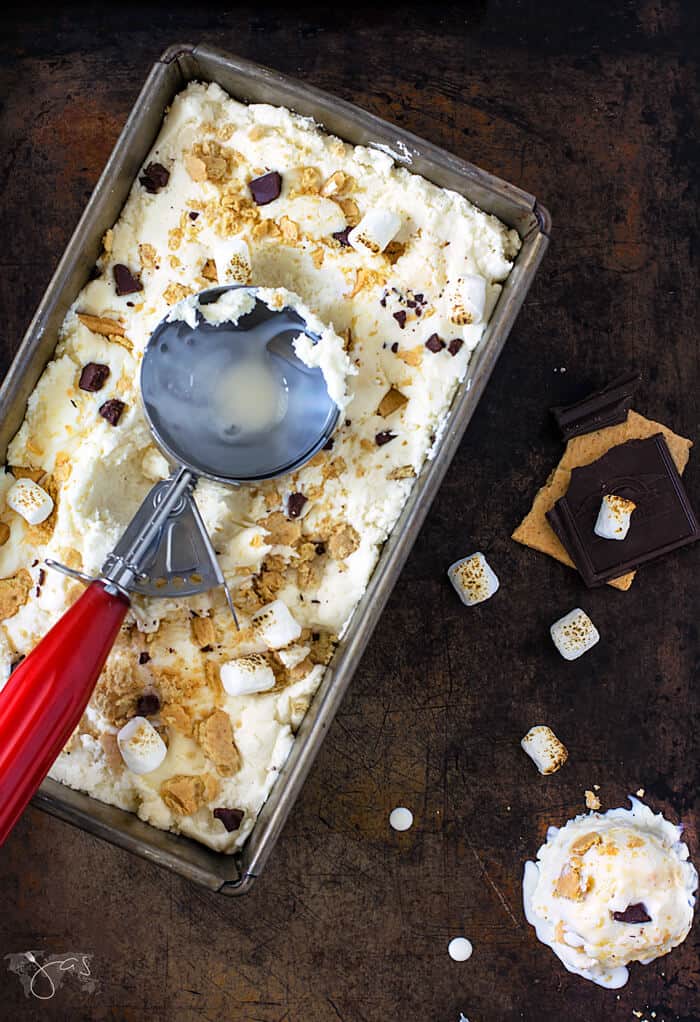 s'mores ice cream in a metal loaf pan with red ice cream scooper.