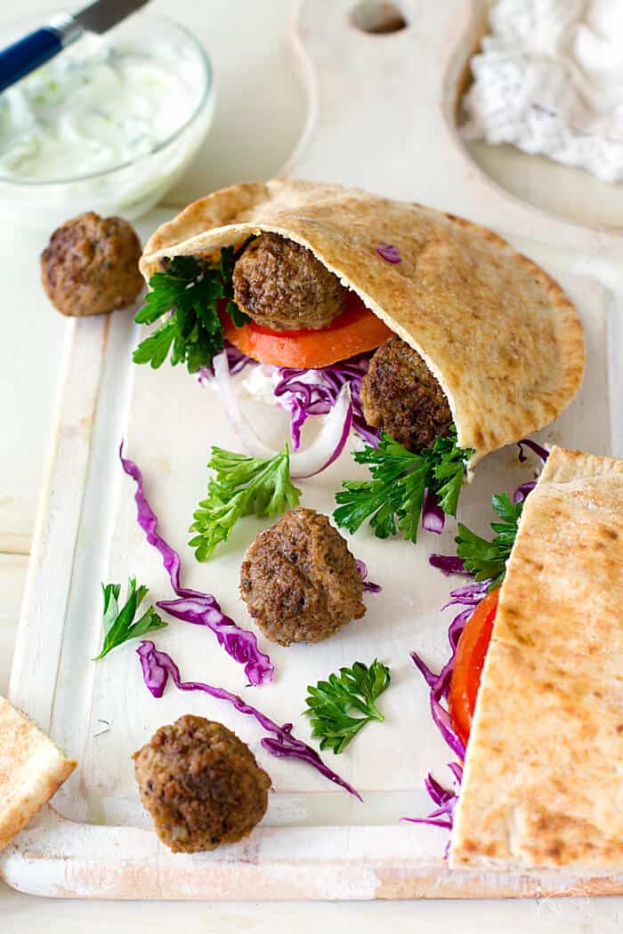 Pita bread and Greek meatballs on a table.
