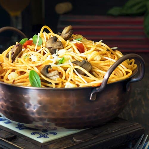 A bowl of food on a table, with Spaghetti and Pasta