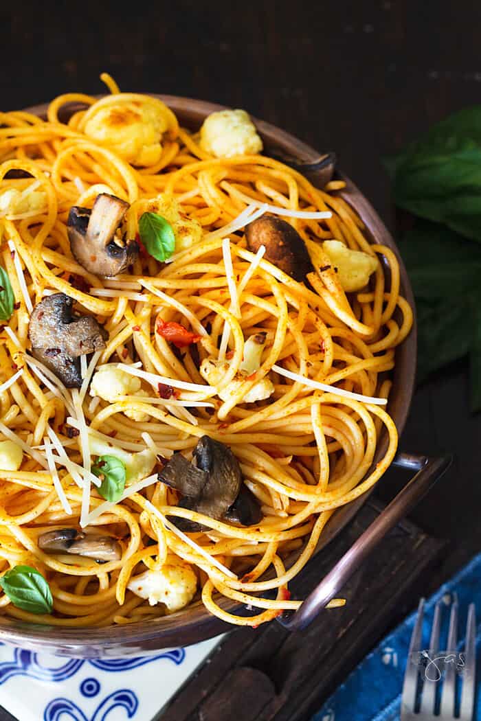 An overhead shot of the bowl with spaghetti, cauliflower and mushrooms