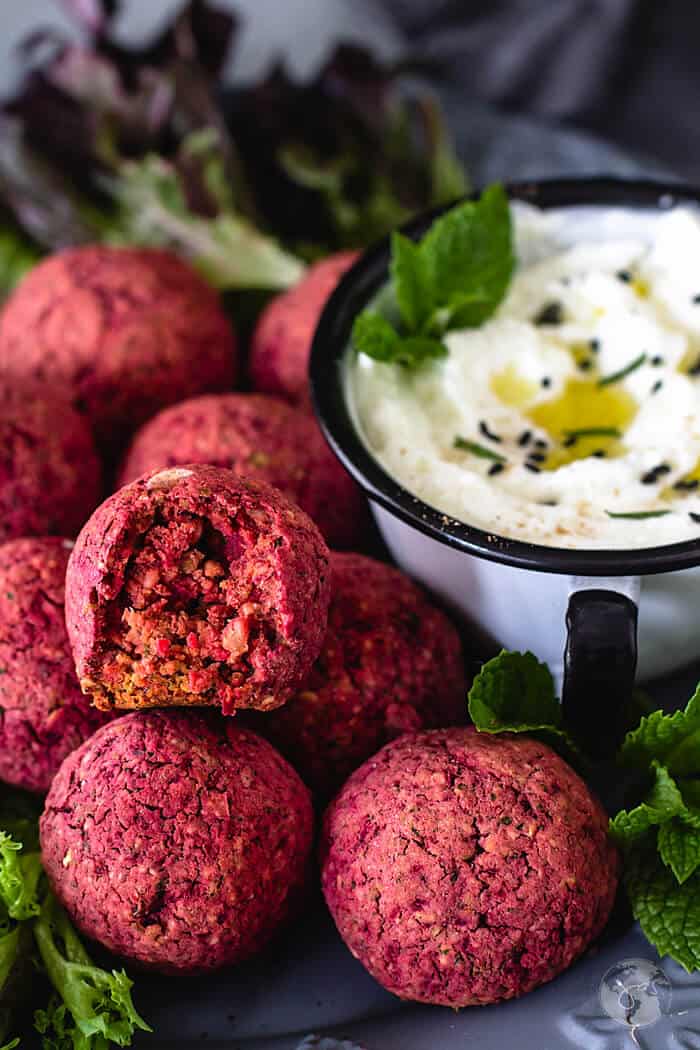 A close up of a bite out of falafel.