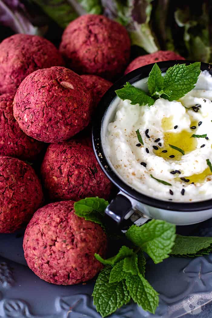 Close up of falafel and yogurt sauce.