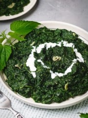 A plate of creamy nettle with a cream swirl.