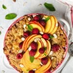 Sweet kugel noodle casserole with sliced peaches and raspberries - overhead