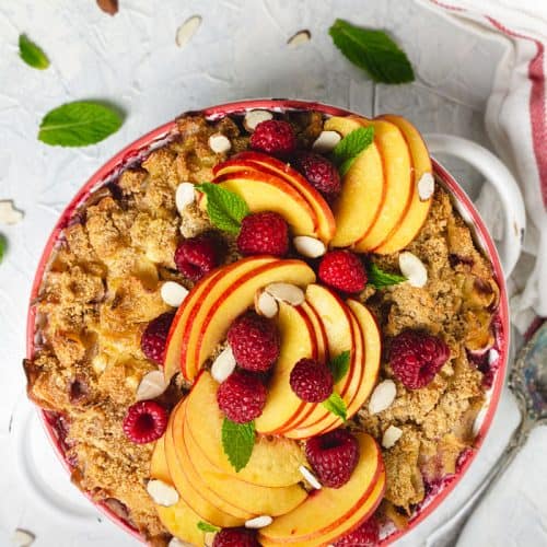 Sweet kugel noodle casserole with sliced peaches and raspberries - overhead