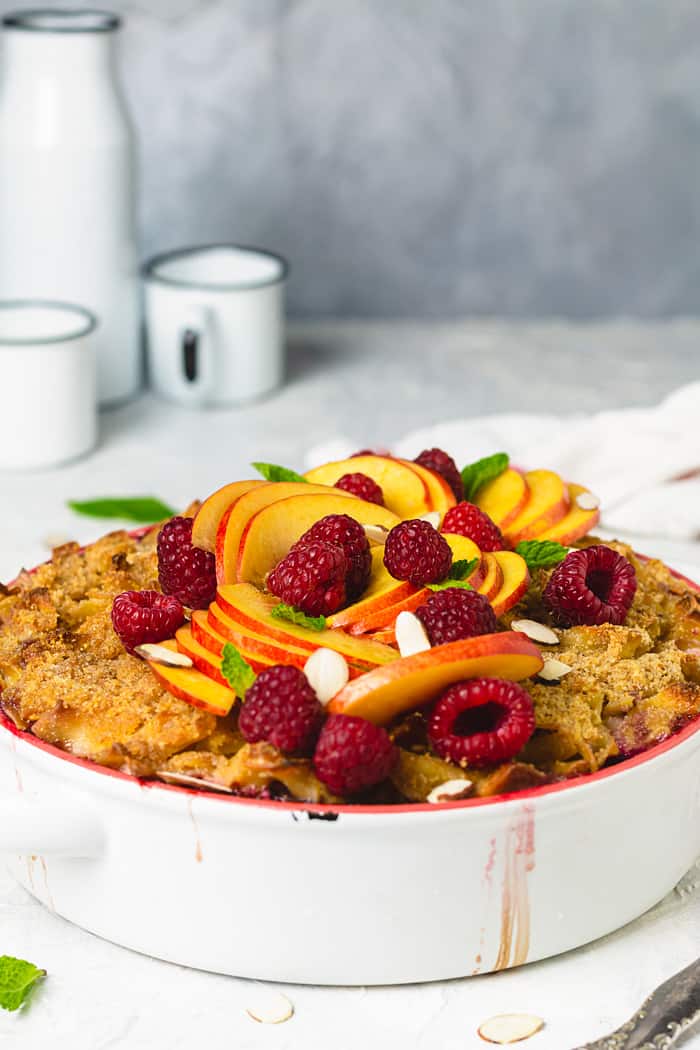 Jewish casserole with pasta, peaches, raspberries in a creamy vanilla sauce.