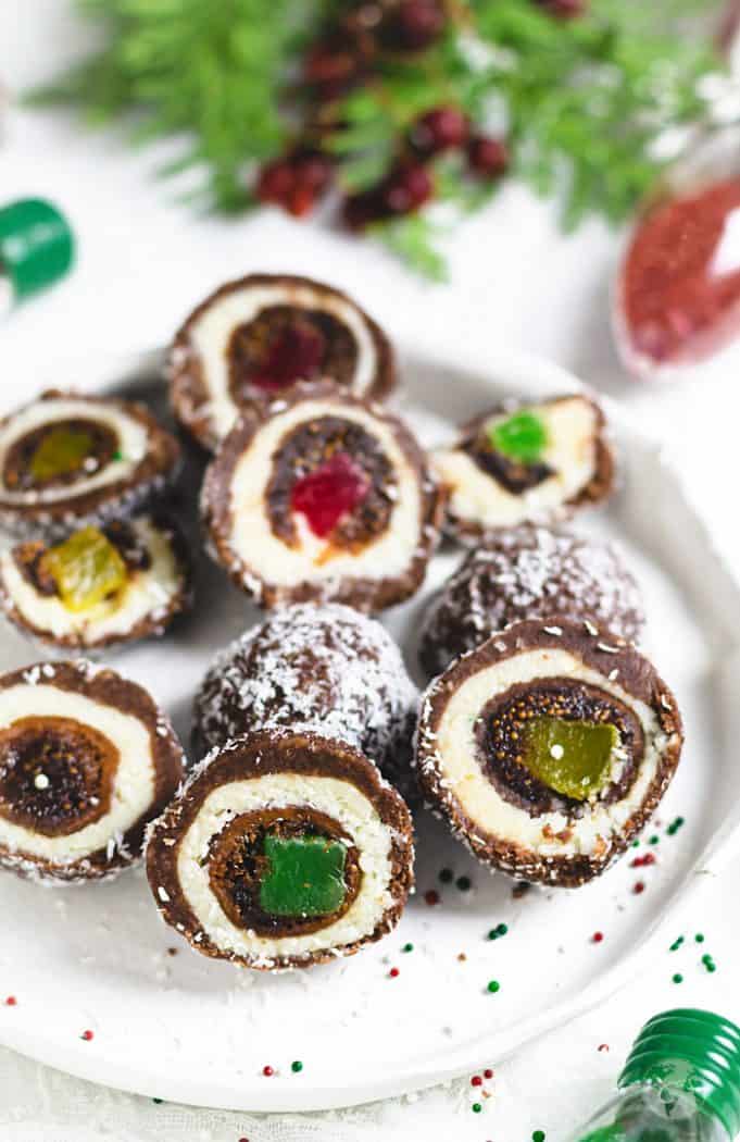 Sliced holiday dessert made with stuffed figs and covered with coconut and chocolate layers