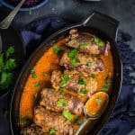 Stuffed beef roll-ups in the pan.