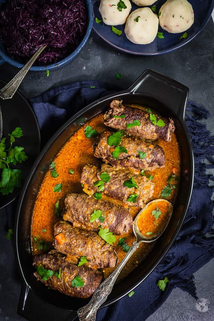 Stuffed beef roll-ups in the pan.