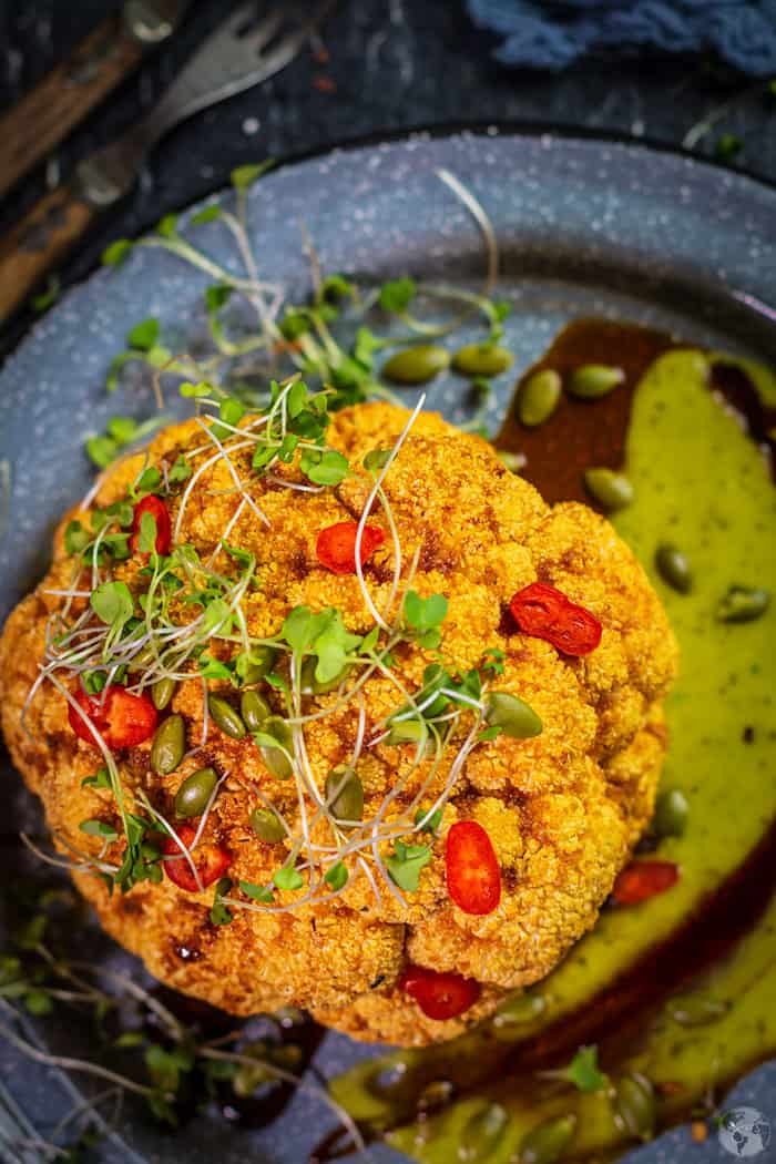 Cauliflower roasted and topped with gastrique sauce on a bed of guacamole salsa