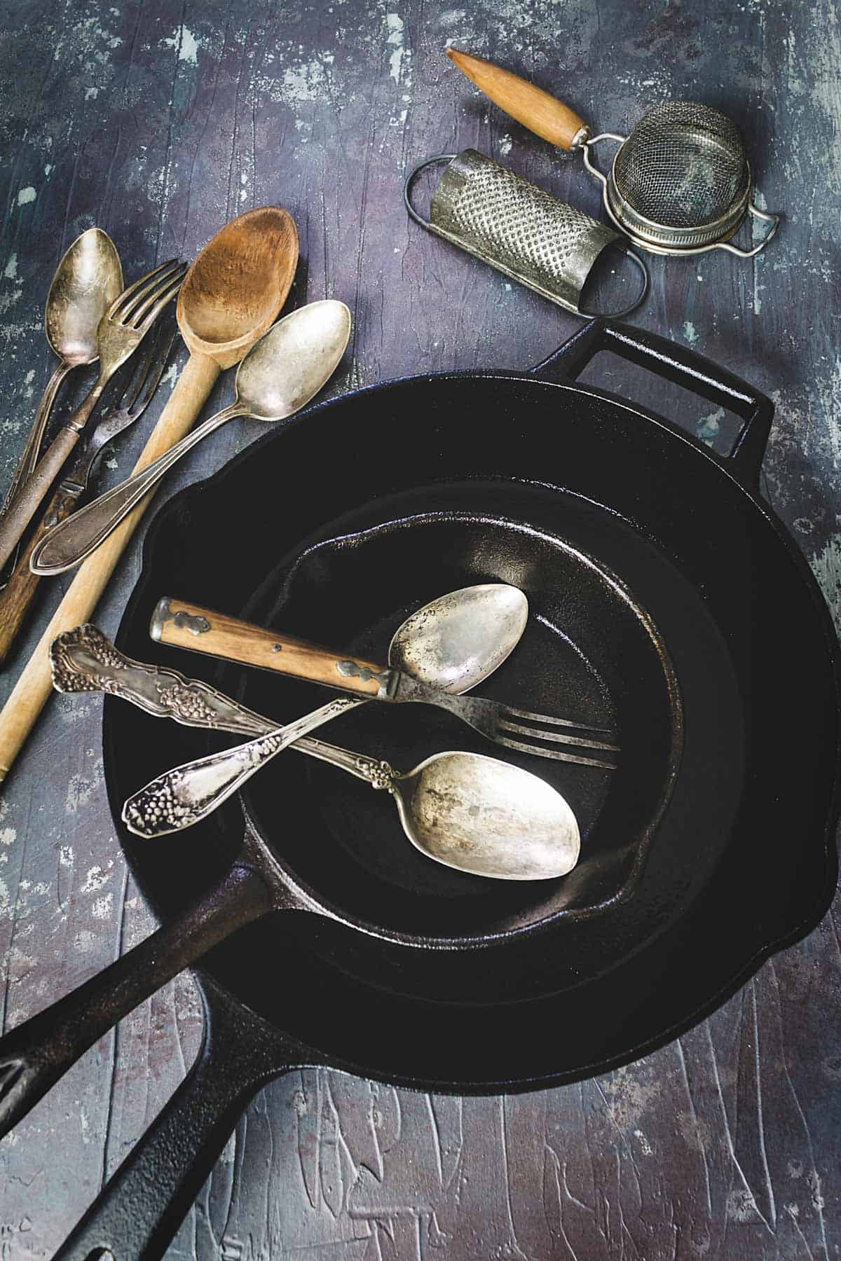 Cast-iron skillets on the table with silverware.