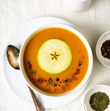 Overhead view of the dish in a bowl, spices, and salt and pepper shaker